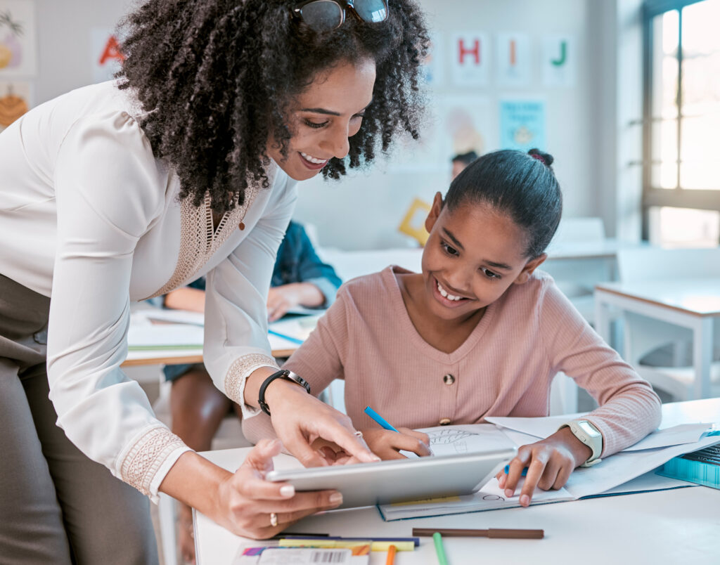 tablet education teacher kid learning writing digital support helping classroom mentor black woman person teaching child technology english language creative development